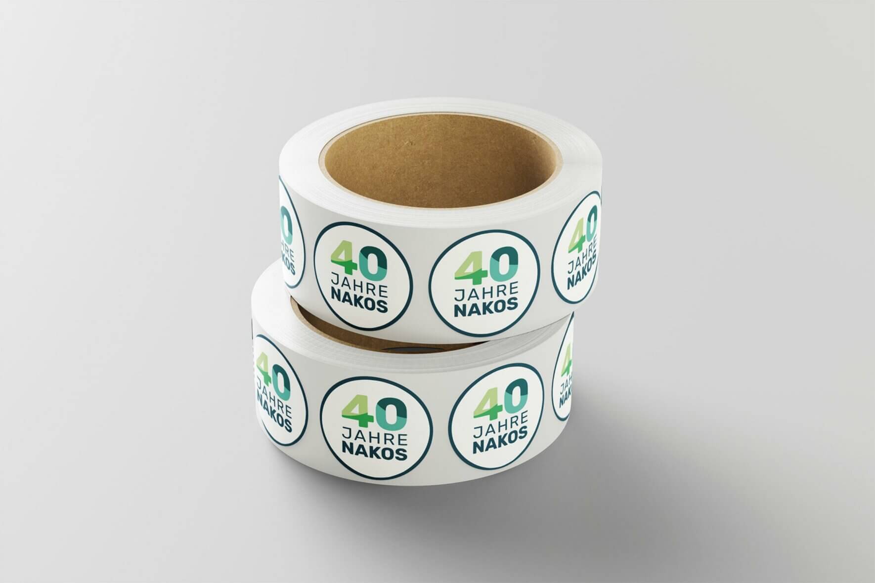 2024-09-18-NAKOS-40-Jahre-Sticker-Mockup-002 2024-09-18-NAKOS-40-Jahre-Sticker-Mockup-002
